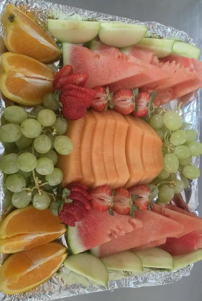 A platter of sliced fruit